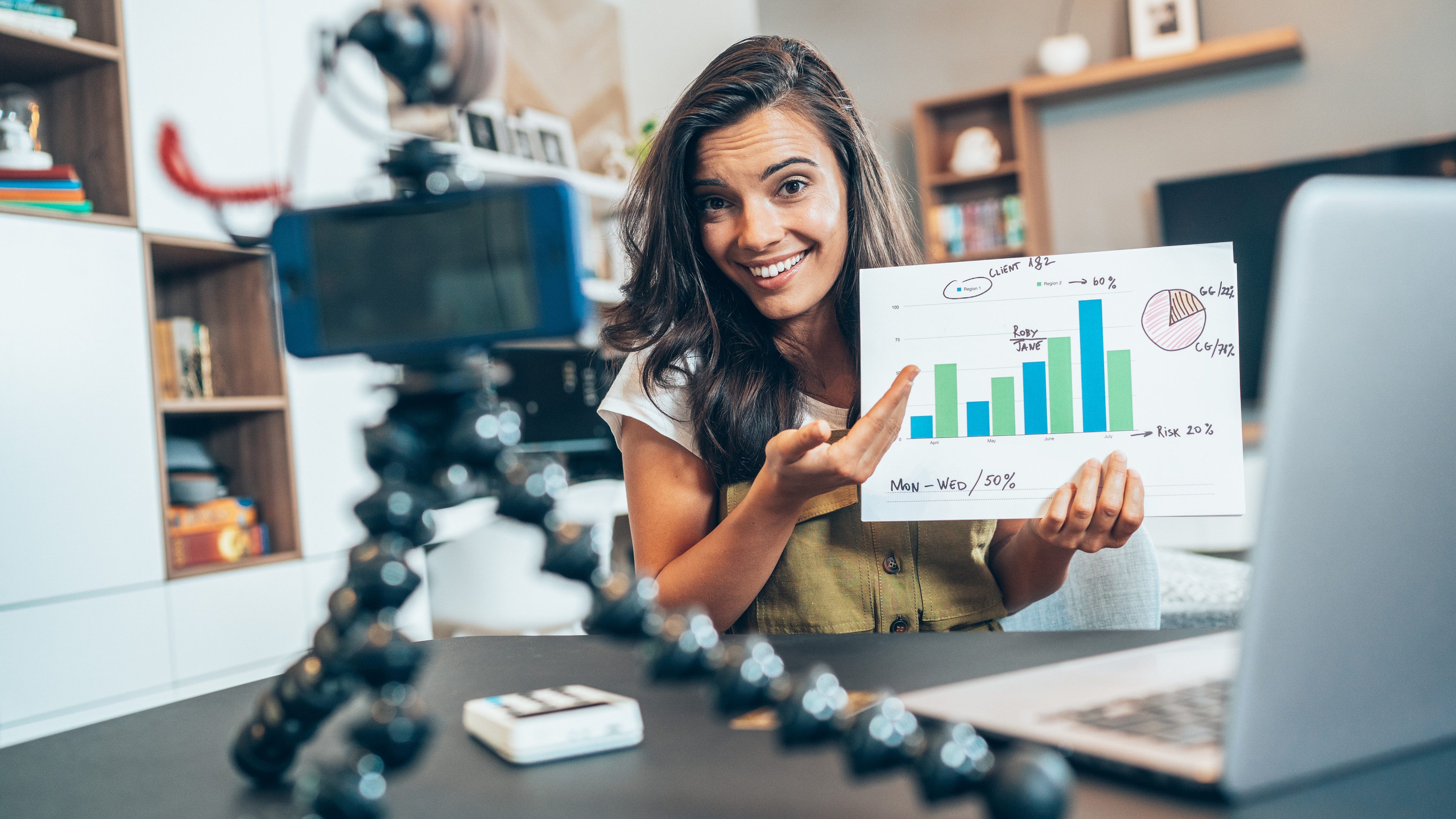 Young female vlogger recording video tutorial session of finance and economy